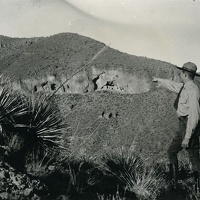 Ranger Pointing to the Upper Cliff Dwelling